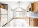 Bright kitchen featuring tile floors, wood cabinets, a mosaic backsplash and stainless steel appliances at 12702 Slippery Rock Rd, Indianapolis, IN 46236