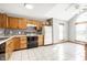 Bright kitchen featuring tile floors, wood cabinets, a mosaic backsplash and stainless steel appliances at 12702 Slippery Rock Rd, Indianapolis, IN 46236