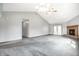 Spacious living room with gray carpet, a brick fireplace, and plenty of natural light at 12702 Slippery Rock Rd, Indianapolis, IN 46236
