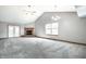 Spacious living room with gray carpet, a brick fireplace, and plenty of natural light at 12702 Slippery Rock Rd, Indianapolis, IN 46236