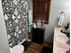 Cozy bathroom featuring a decorative shower curtain, a vanity with sink, and muted blue walls at 128 Mulberry Rd, Anderson, IN 46017