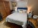 Comfortable bedroom featuring a ceiling fan, stylish lamps on the bedside tables, and a cozy, inviting queen bed at 128 Mulberry Rd, Anderson, IN 46017