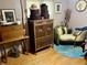 A bedroom featuring a comfortable chaise lounge, vintage dresser and gold-framed pictures for a warm, inviting feeling at 128 Mulberry Rd, Anderson, IN 46017