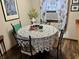 Cozy dining nook features a round table with decorative lace tablecloth and natural light at 128 Mulberry Rd, Anderson, IN 46017