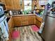 Functional kitchen with wood cabinets, laminate countertops, and modern stainless steel appliances at 128 Mulberry Rd, Anderson, IN 46017