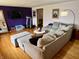 Spacious living room boasts hardwood floors, a sectional sofa, and a contemporary entertainment setup at 128 Mulberry Rd, Anderson, IN 46017