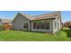 Side exterior of home with gray siding and lovely green lawn on a sunny day at 138 President W Trl, Indianapolis, IN 46229
