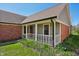 Charming front porch with classic railing and brick accents, complemented by landscaping at 138 President W Trl, Indianapolis, IN 46229