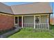 Quaint front porch with classic railing and brick accents, complemented by landscaping at 138 President W Trl, Indianapolis, IN 46229