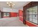 Spacious living room with large windows and neutral carpet, offering plenty of natural light and a cozy atmosphere at 138 President W Trl, Indianapolis, IN 46229