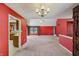 Large living room with high ceilings, ceiling fan, neutral carpet and doorways to the kitchen at 138 President W Trl, Indianapolis, IN 46229