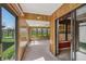 A view of a sunroom that opens to a carpeted room at 138 President W Trl, Indianapolis, IN 46229