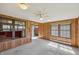 Sunroom featuring wood walls, carpet flooring and a ceiling fan at 138 President W Trl, Indianapolis, IN 46229