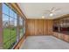 Sunroom with wood paneling, carpet flooring and large windows providing abundant natural light at 138 President W Trl, Indianapolis, IN 46229