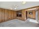 Sunroom featuring carpet floors, wood walls, and a ceiling fan at 138 President W Trl, Indianapolis, IN 46229