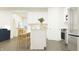 Bright kitchen with stainless steel appliances and white cabinetry, leading into the living area at 15371 Alperton Rd, Fishers, IN 46037