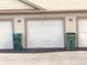 Close up of garage exterior showing trash receptacles and door numbers at 1711 Lafayette Ave # 5, Lebanon, IN 46052