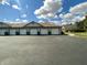 Exterior view of multiple garages with white doors and attached driveways and trash bins at 1711 Lafayette Ave # 5, Lebanon, IN 46052