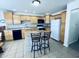 Bright kitchen with light wood cabinets, black appliances and center island with seating at 1711 Lafayette Ave # 5, Lebanon, IN 46052