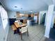 Open kitchen and dining area with an island, bright lighting and tile floors at 1711 Lafayette Ave # 5, Lebanon, IN 46052