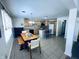 Open kitchen and dining area with an island, bright lighting and tile floors at 1711 Lafayette Ave # 5, Lebanon, IN 46052