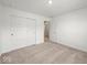 Bright bedroom features neutral carpeting, white walls, and double door closet for ample storage space at 17293 Rancorn Pl, Westfield, IN 46074
