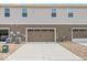 Back exterior view of townhome featuring a two-car garage and paved driveway, and hardiplank siding at 17293 Rancorn Pl, Westfield, IN 46074