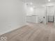 Bright hallway with neutral carpet, white walls, and a laundry area for easy access at 17293 Rancorn Pl, Westfield, IN 46074