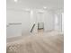 Bright hallway featuring neutral carpet, white walls, and a convenient laundry area at 17293 Rancorn Pl, Westfield, IN 46074