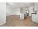 Bright open-concept kitchen with stainless steel appliances, quartz countertops and hardwood flooring, flowing into the living area at 17293 Rancorn Pl, Westfield, IN 46074