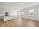 Bright open-concept kitchen featuring an island with sleek countertops and stainless appliances, seamlessly connected to the living area at 17293 Rancorn Pl, Westfield, IN 46074