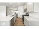 Bright open-concept kitchen featuring an island with sleek countertops and stainless appliances, seamlessly connected to the living area at 17293 Rancorn Pl, Westfield, IN 46074