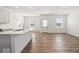 Bright open-concept kitchen featuring an island with sleek countertops and stainless appliances, seamlessly connected to the living area at 17293 Rancorn Pl, Westfield, IN 46074