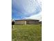 A home's backyard boasts a lush lawn and a solid fence, creating a secure and inviting outdoor space at 1836 Queensbridge N Cir, Indianapolis, IN 46219