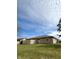 Backyard view featuring a home with a fenced yard and manicured lawn, ideal for outdoor enjoyment and privacy at 1836 Queensbridge N Cir, Indianapolis, IN 46219