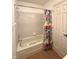 Bathroom with combined tub and shower featuring a shower curtain, suitable for relaxation and practical needs at 1836 Queensbridge N Cir, Indianapolis, IN 46219