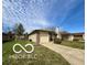 Single-story home with an attached garage and driveway on a sunny day at 1836 Queensbridge N Cir, Indianapolis, IN 46219