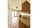 Functional kitchen with wood cabinets, laminate countertops, and a sliding glass door at 1836 Queensbridge N Cir, Indianapolis, IN 46219
