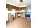 Kitchen with wood cabinets, laminate countertops, and wood laminate flooring at 1836 Queensbridge N Cir, Indianapolis, IN 46219