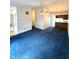 Inviting living room with blue carpeting, neutral walls, and access to the kitchen at 1836 Queensbridge N Cir, Indianapolis, IN 46219