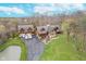 Aerial shot of the property featuring the home, pond, garage, and surrounding trees at 222 Stony Ln, Noblesville, IN 46060