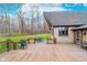 Expansive wooden deck with outdoor seating and a view of the backyard and mature trees at 222 Stony Ln, Noblesville, IN 46060