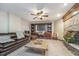 Basement living area with comfortable seating, stone fireplace, and wooden built-in shelving at 222 Stony Ln, Noblesville, IN 46060