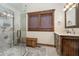 Bathroom featuring a glass walk-in shower with seat, and wooden accents at 222 Stony Ln, Noblesville, IN 46060