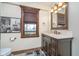 Elegant bathroom with a dark wood vanity, granite countertop and stylish fixtures at 222 Stony Ln, Noblesville, IN 46060