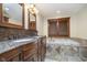 Luxurious bathroom featuring double vanities, a soaking tub, and beautiful tile work at 222 Stony Ln, Noblesville, IN 46060