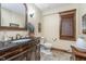 Bathroom featuring a dark wood vanity, elegant fixtures, and stylish decor at 222 Stony Ln, Noblesville, IN 46060