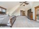 Spacious bedroom featuring neutral tones, wood trim, a ceiling fan, and ensuite bathroom access at 222 Stony Ln, Noblesville, IN 46060