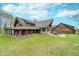 Exterior elevation of a large home with a covered porch, spacious lawn, and mature landscaping at 222 Stony Ln, Noblesville, IN 46060