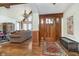 Inviting foyer with hardwood floors, wood trim, and a decorative chandelier at 222 Stony Ln, Noblesville, IN 46060